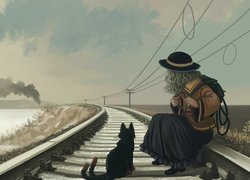 Dziewczynka z kotem na torach kolejowych