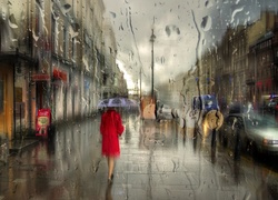 Kobieta pod parasolem w deszczu