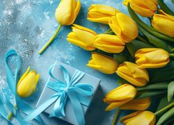 Prezent i żółte tulipany na niebieskim tle