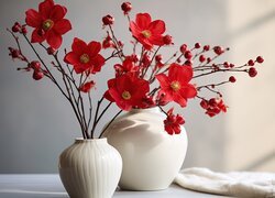 Czerwone kwiaty w białych wazonach