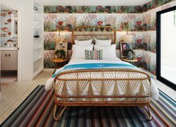 Kolorowe wnętrze sypialni z ratanowym łóżkiem
