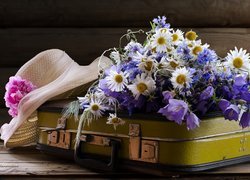 Kwiaty polne z kapeluszem i walizką
